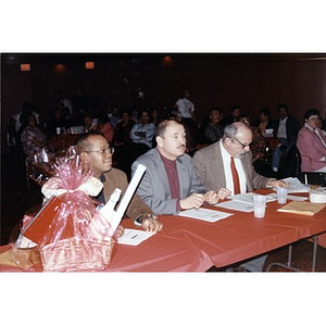 Panel of three judges (?) at an evening of musical performances at the Jorge Hernandez Cultural Center.