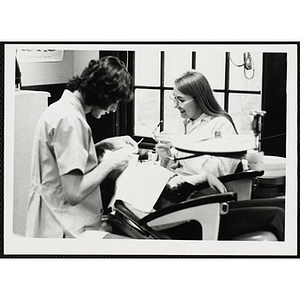 Two young women working on projects for their arts and crafts class at the Boys' Clubs of Boston