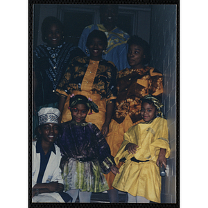 Girls and women in traditional dress pose for a group shot