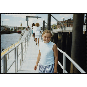 A girl poses for a shot on a dock in Charlestown