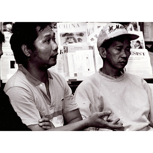 Three Lei Jing Restaurant construction workers seated at the Chinese Progressive Association headquarters