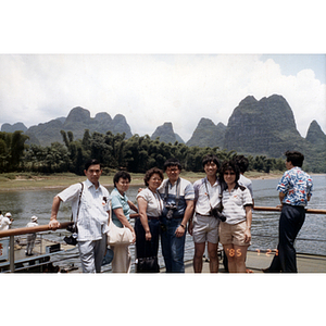 Association members stand in a ferry while touring Guilin, China