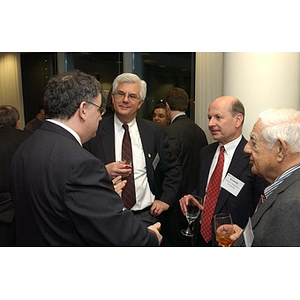 George Makris and three men converse at The National Council Dinner