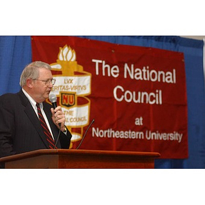 Neal Finnegan speaks at a podium at The National Council Dinner