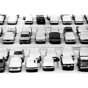 Students return to their snow-covered cars in a parking lot