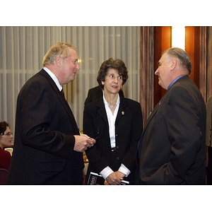 Neal Finnegan (CBA '61), left, and Harry P. Keegan III (CBA '64), right, conversing with another guest at the College of Business Administration's Distinguished Service Awards ceremony