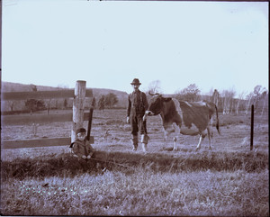 Man and boy in a cow pasture, Mashpee, Mass.