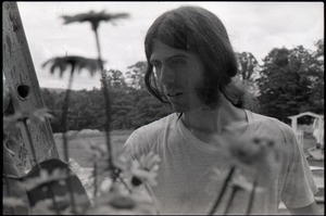 Bruce Geisler looking at flowers in the garden