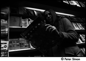 Woman reading Fortune magazine at a Cambridge newsstand