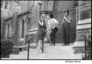 United States Student Press Association Congress: Raymond Mungo (hands clasped in prayer), Marshall Bloom, and an unidentified woman goofing around by a chapel entrance