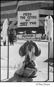 Sign at a Mobilization for Survival antinuclear demonstration near Draper Laboratory, MIT, reading 'Feed the cities and not the monster of nuclear power and arms'