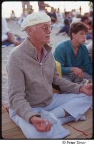 Ram Dass posing in half lotus on the beach