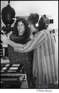 Usha (Cathy Brown) and Peter Simon in a darkroom, next to an enlarger