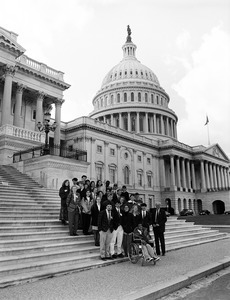 Congressman John W. Olver (right) with group of visitors, posed on the steps of the United States Capitol building