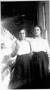 Two female textile workers at a spinning frame. [04]