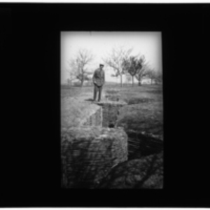 Soldier overlooks a trench