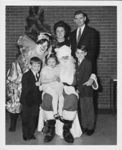 Suffolk University Vice President and Treasurer Francis X. Flannery and his family with Santa Claus and a clown