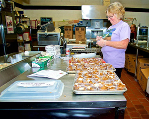 Kathy Poor is setting up the food for the cook-off