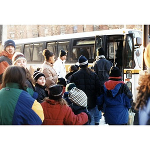 Villa Victoria children and chaperones boarding a city bus.