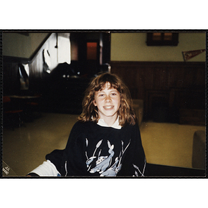 A teenage girl from the Charlestown Boys and Girls Club smiling for the camera