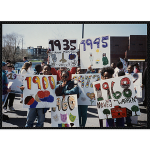 Several boys and girls pose with their parade signs during the Boys and Girls Clubs of Boston 100th Anniversary Celebration Parade