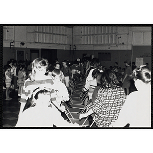 A Large group of children playing a game of musical chairs