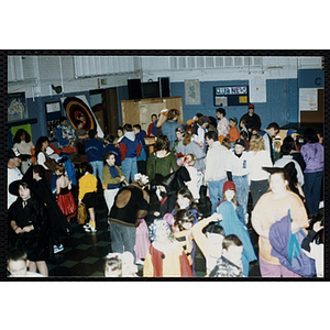 Children in costumes and adults attend a Halloween party