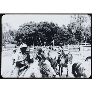 A group of teenage boys ride horses