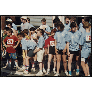 Teenagers and children gather at the start line of the Battle of Bunker Hill Road Race