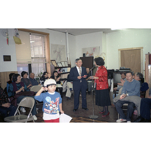 Man beside Suzanne Lee after having received an award or gift at the Chinese Progressive Association's celebration of the Chinese New Year