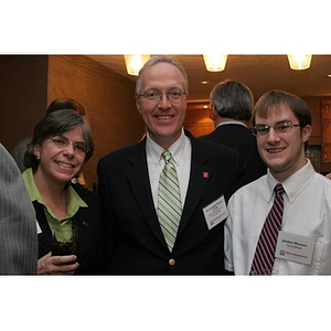 Jordan Munson poses with a man and Elizabeth Hill at a Torch Scholars event