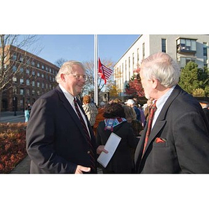 Neal Finnegan converses with another man at the Veterans Memorial dedication ceremony