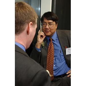 Dr. Homer H. Pien speaks with another man at The National Council Dinner