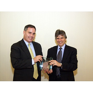 Dr. Ira. R. Weiss, right, presents College of Business Administration's Distinguished Service Award to Joseph Malarny, CBA '82