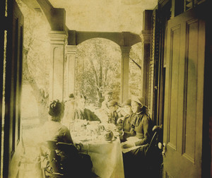 Half-length group portrait of the Bowen Family, seated, at tea, location unknown, undated