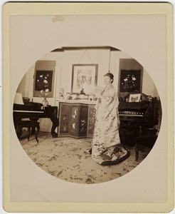 Abby F. Blanchard in the parlor, with fan and kimono