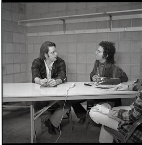 Bob Weir sitting at table with Mitch Sieser (l. to r.)