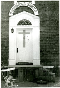 View of the doorway (with sign) to a Brotherhood of the Spirit house on Main Street