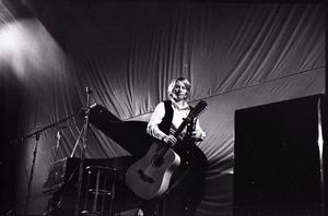 Unidentified female twelve-string guitar player, leaving stage