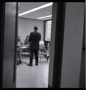 View through an open door of a class is session, UMass Amherst