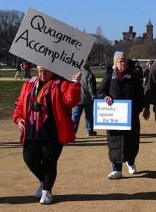 Protester on the National Mall, marching against the War in Iraq, carrying sign reading 'Quagmire accomplished'