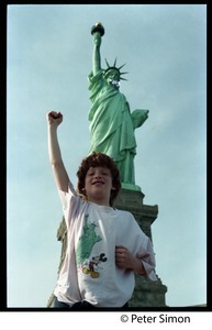 Statue of Liberty: view from the front, with child, raised fist, standing in foreground