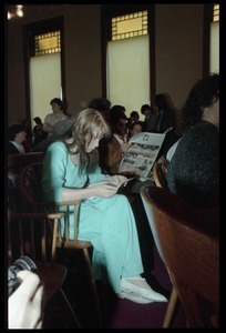 Scene inside the courtroom following acquittal in the CIA protest trial: Amy Carter seated in a chair