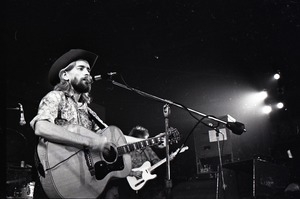 New Riders of the Purple Sage opening for the Grateful Dead at Sargent Gym, Boston University: John 'Marmaduke' Dawson playing acoustic guitar and singing