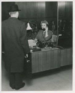 Mrs. Frances Marsala seated in her wheelchair working as a receptionist