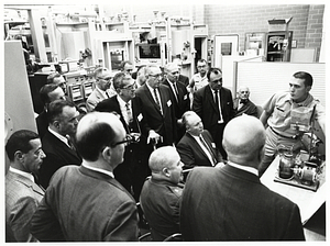 Unidentified soldier demonstrating device for Mayor John F. Collins and group of unidentified men