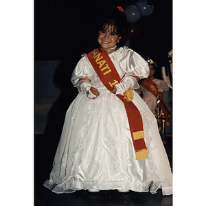 A girl wearing a Fantasía sash smiles during the Festival Puertorriqueño