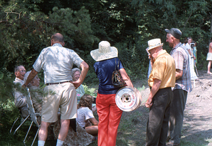 Arthur E. Rosenburg, Ella M. Rosenburg, and Martha Ferris (left to right seated in lawn chairs) talk to people at the 2 August 1975 Moon Barn raising.
