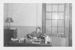 Suffolk University Professor and Registrar Catherine T. Judge (Law) in the Registrar's office, photograph, circa 1955