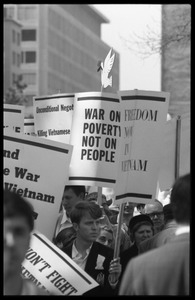 Antiwar protesters during the March on Washington carrying signs 'Freedom now in Vietnam,' 'War on Poverty, not on people,' and 'End the war in Vietnam'